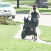 Milf pushing her baby in a stroller in tight leggings Milf walking baby in leggings
