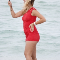 Thick and sexy blonde in skimpy skirt on the beach