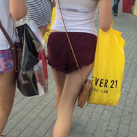 Cheeky brunette in maroon shorts