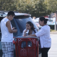 Latina mom in pants with daughter outside TJ Maxx Latina mom and daughter