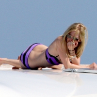 Avril Lavigne looking sexy in purple bikini on a boat Avril Lavigne in purple bikini