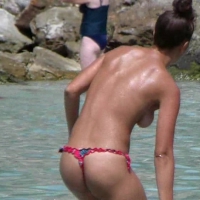 Topless babe in micro thong