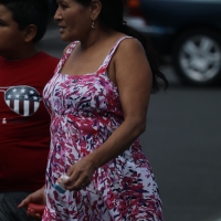 Latina grandma in a parking lot in colorful dress Latina grandma in dress