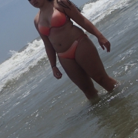 Thick beach girl in peach bikini