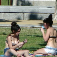 Two teens at the park in shorts and bikini tops