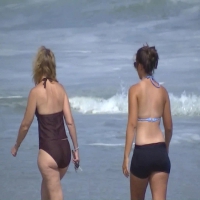 Milf and daughter on the beach