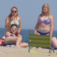 3 girls on the beach in bikinis with big boobs, one brunette and two blondes 3 big boobed bikini girls
