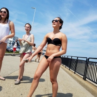 Cute brunette looking sexy in black bikini with friends Cute brunette in black bikini