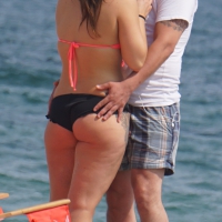 Sexy milf with tattoos in black and pink bikini on the beach Milf with tattoos in bikini