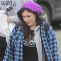 A cute brunette in leggings boots and hat Cute brunette in leggings and boots