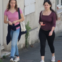 Thick girl in leggings with big boobs walking with friend in jeans Thick girl in leggings with big boobs