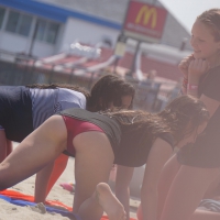A group of teens in bikinis on the beach Group of teens on the beach