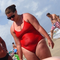 Fat chick on the beach in a red swimsuit Fat chick in red swimsuit