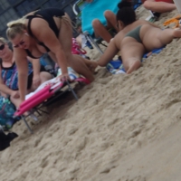Fat blonde on the beach in a black swimsuit with big tits Fat blonde in black swimsuit