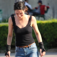 Hot brunette skateboarder in tight jeans and with hard nipples Hot brunette skateboarder