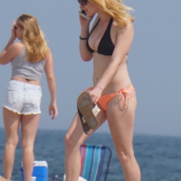 Hot blonde in peach and black bikini on the beach Hot blonde on the beach