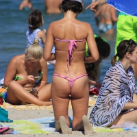 Sexy milf in pink thong bikini on the beach Milf in thong bikini