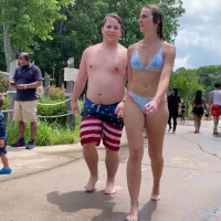 Fat boy with sexy chick at a waterpark