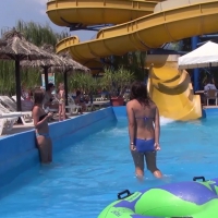 Two pool slide teens