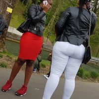 Candid black milfs in tight jeans and a red skirt Candid pair of black milfs