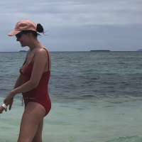 Milf at the beach in a red swimsuit with a nice body Milf in red swimsuit