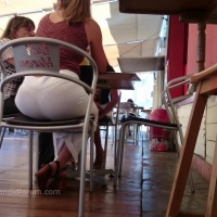 Lady sitting showing her thong