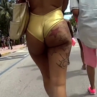 Candid sexy ebony babe with a tattooed booty in a gold swimsuit 24.mp4-2024-08-10-08h03m03s884.jpg