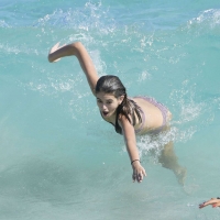 Kaia Gerber paparazzi pics in a purple bikini at the beach 01.jpg