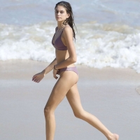 Kaia Gerber paparazzi pics in a purple bikini at the beach 13.jpg
