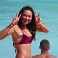 Cutie brunette in purple thong bikini