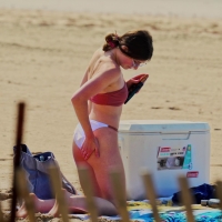 Beach girls applying lotion