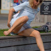 Blonde milf upskirted showing white panties and some pubes Blonde milf upskirted