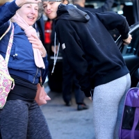 Zendaya taking a selfie with a fan while in grey leggings in New York City 01.jpg