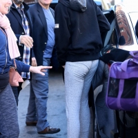 Zendaya taking a selfie with a fan while in grey leggings in New York City 02.jpg
